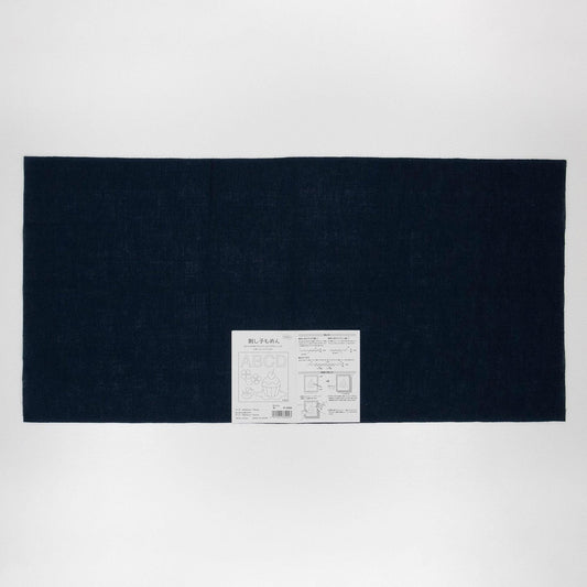 The image is a black rectangular fabric with a white label in the center, which appears to be a product label or instructions.