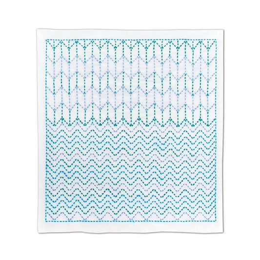 a square with a repeating pattern of zigzag lines in shades of blue and white.