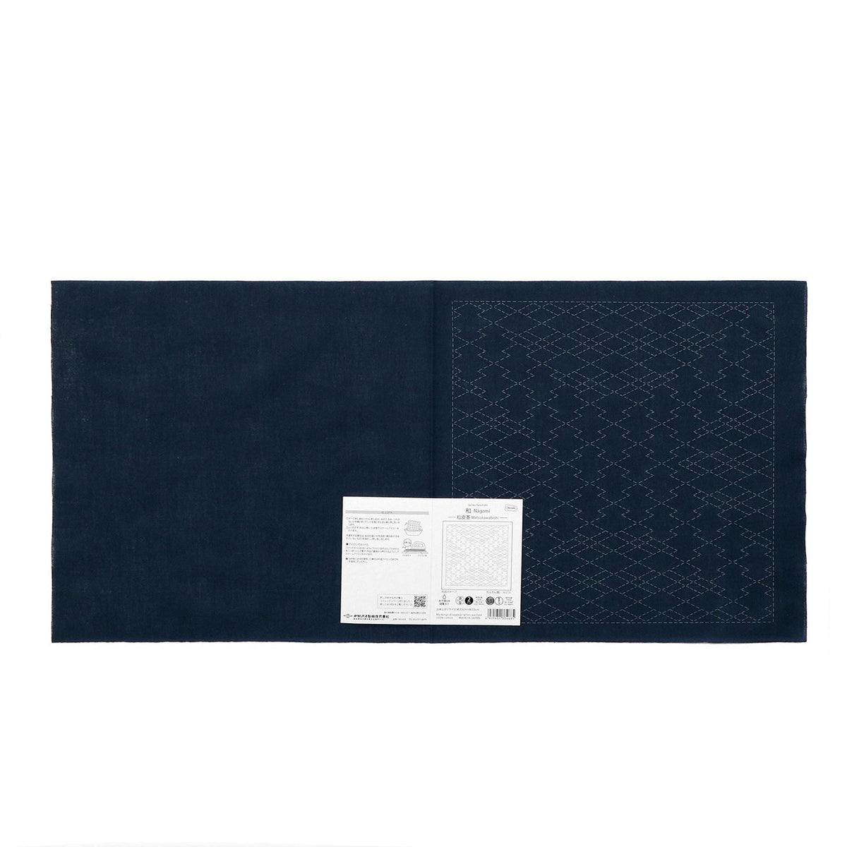The image is a dark blue fabric with a white label attached to it, which appears to be a piece of paper or a printed document.