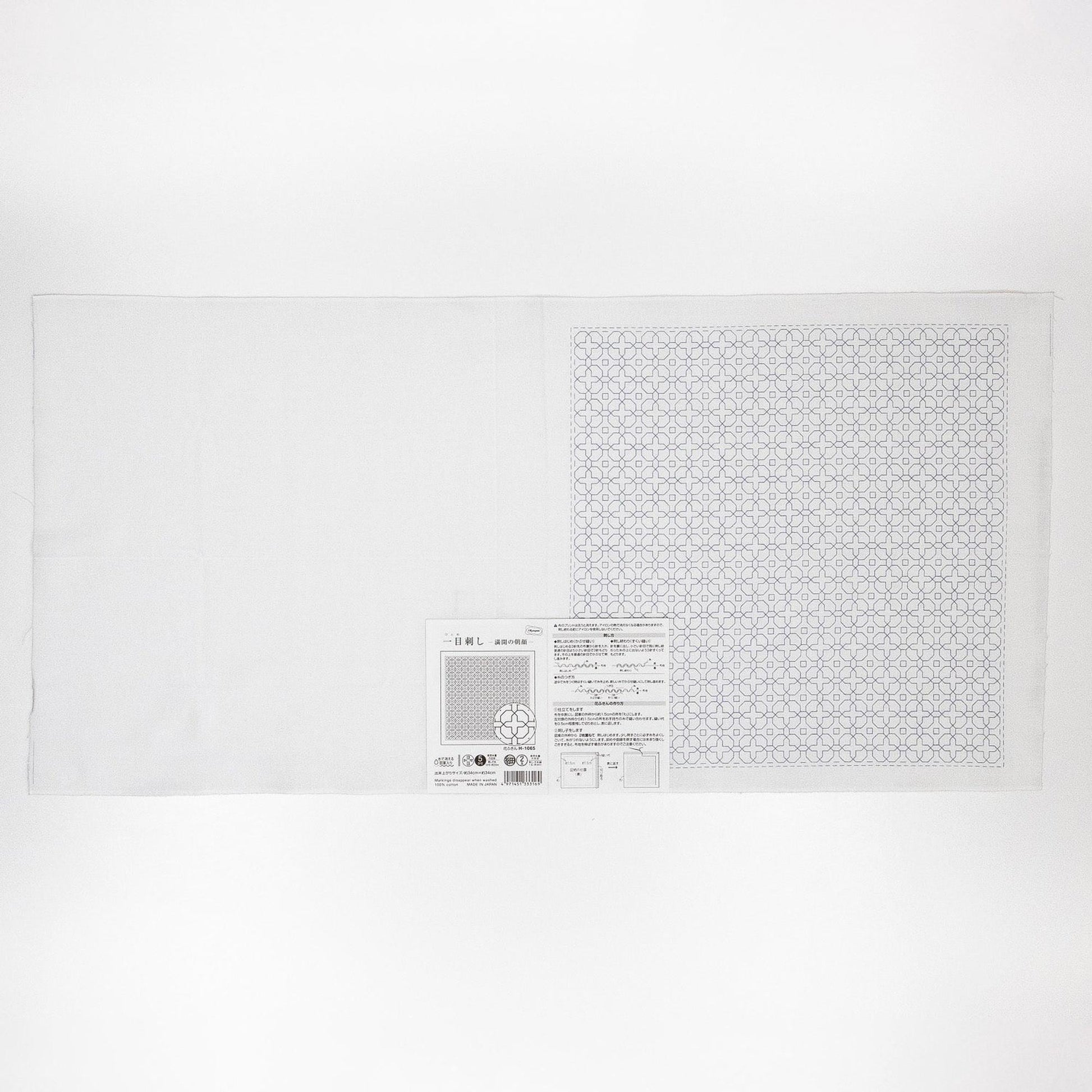 The image is a white sheet of paper with a black and white geometric pattern on it.