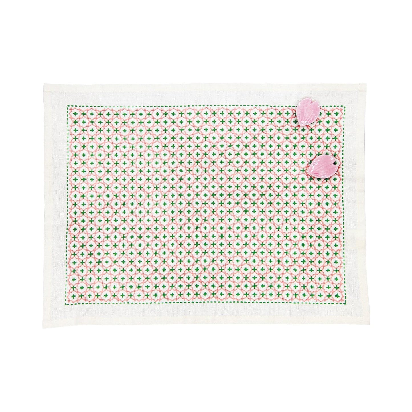 a square-shaped placemat with a green and white geometric pattern.
