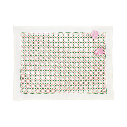 a square-shaped placemat with a green and white geometric pattern.