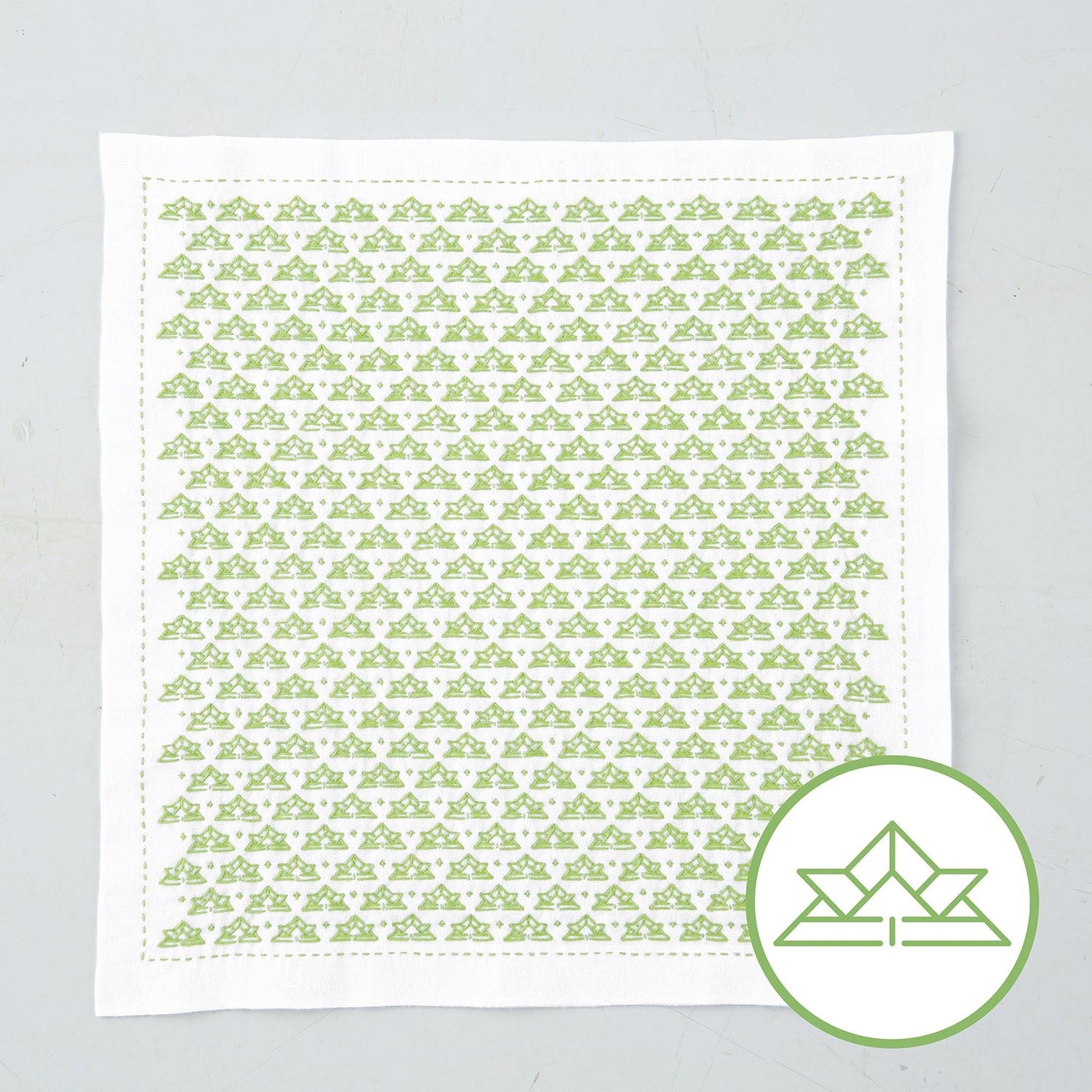 a square piece of fabric with a repeating pattern of green triangles.