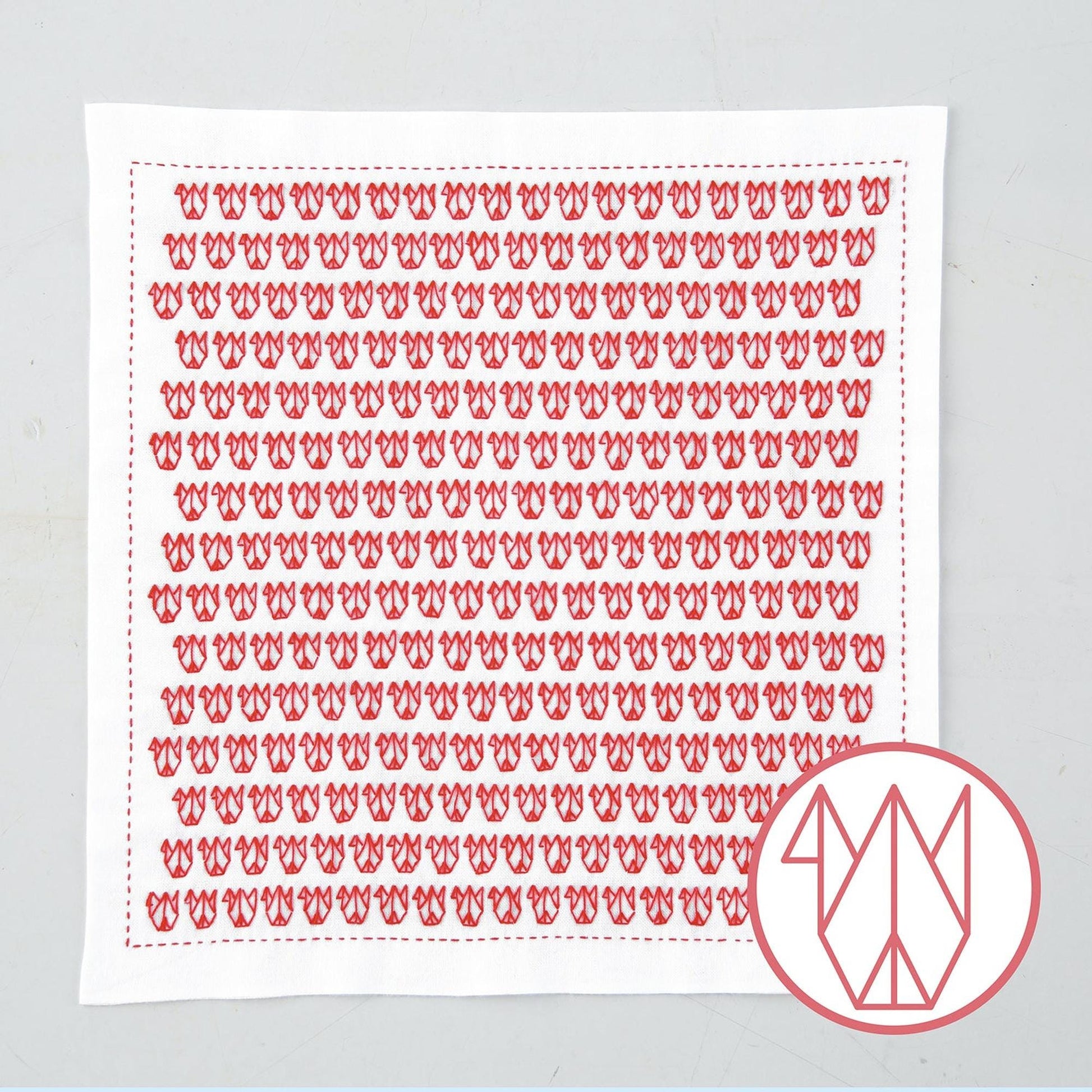 a square piece of fabric with a repeating pattern of red flowers or butterflies.