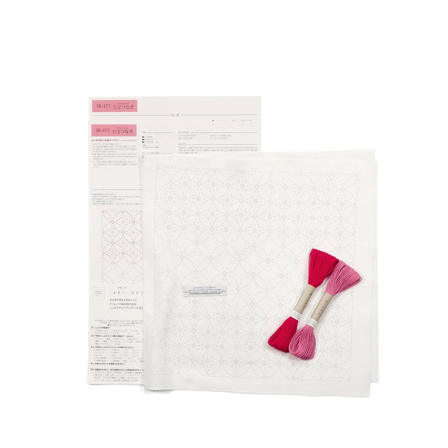 a sewing kit with instructions and materials, including a pattern, thread, and a pair of scissors.