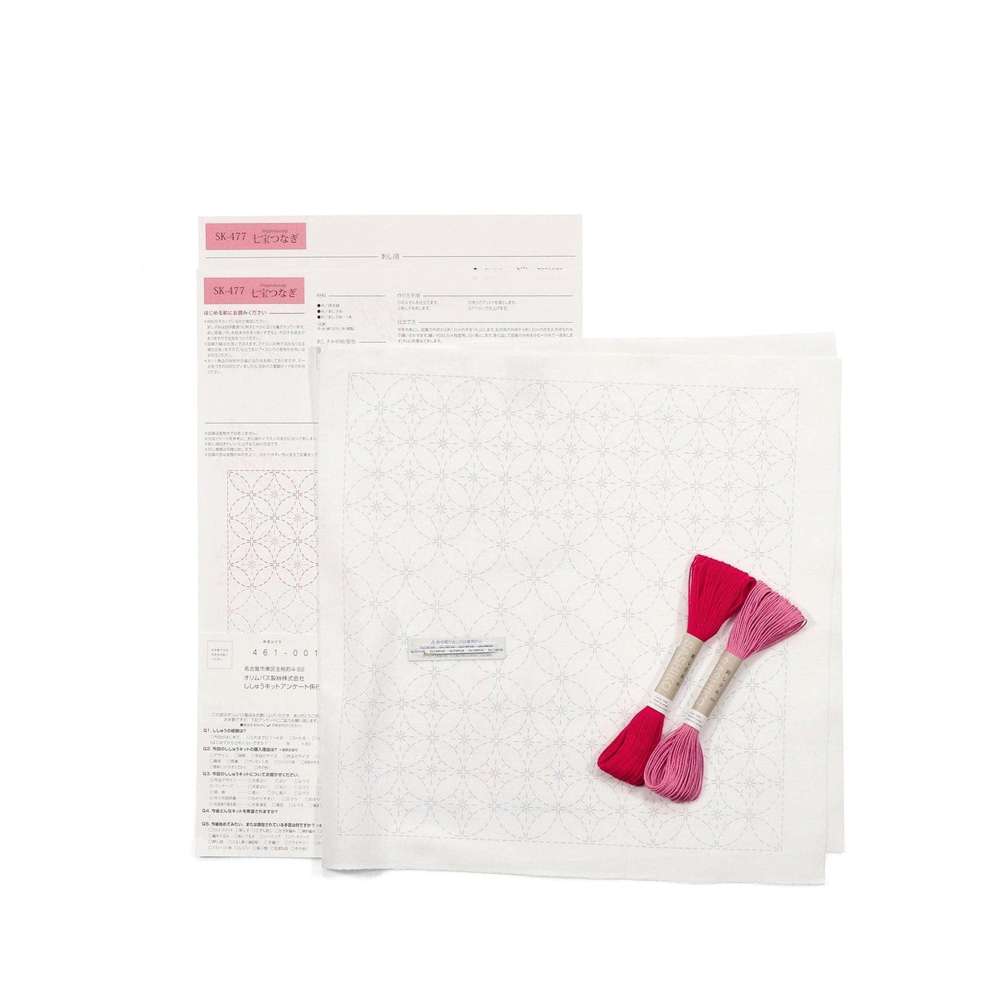 a sewing kit with instructions and materials, including a pattern, thread, and a pair of scissors.