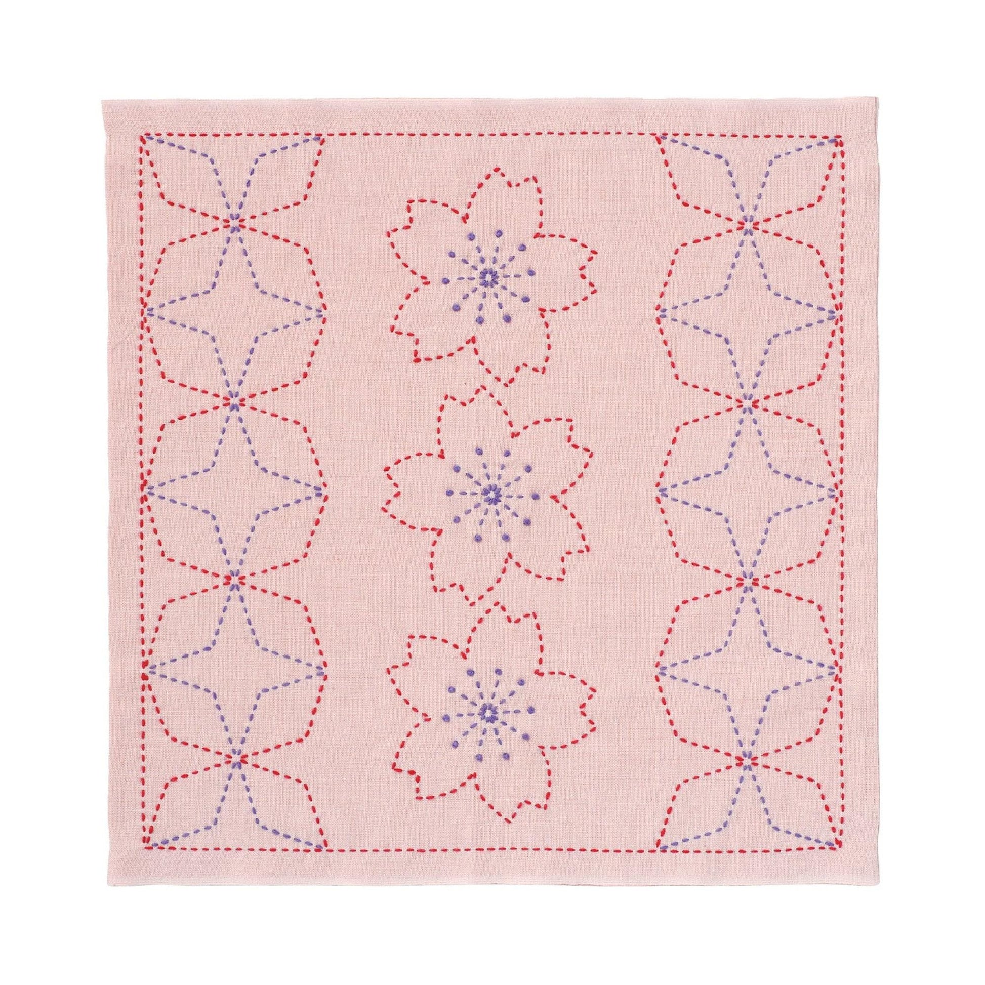 a square with a repeating pattern of pink flowers and red stars. The flowers are outlined in red and the stars are outlined in blue, creating a visually striking design.