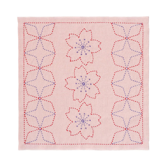 a square with a repeating pattern of pink flowers and red stars. The flowers are outlined in red and the stars are outlined in blue, creating a visually striking design.