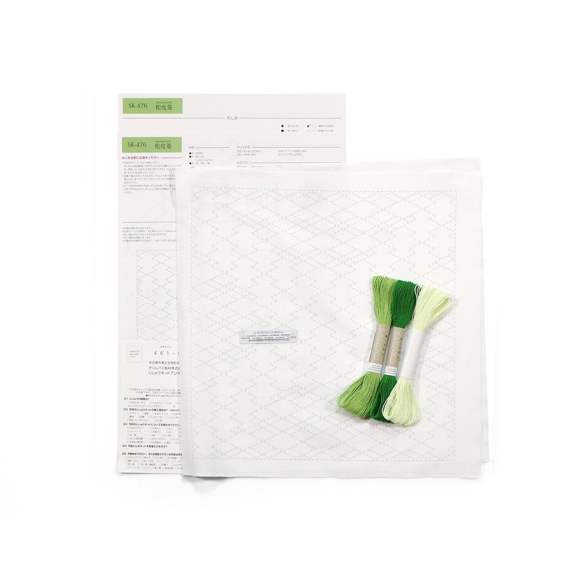 a set of embroidery floss and a pattern paper, along with some instructions or a list, all placed on a white background.