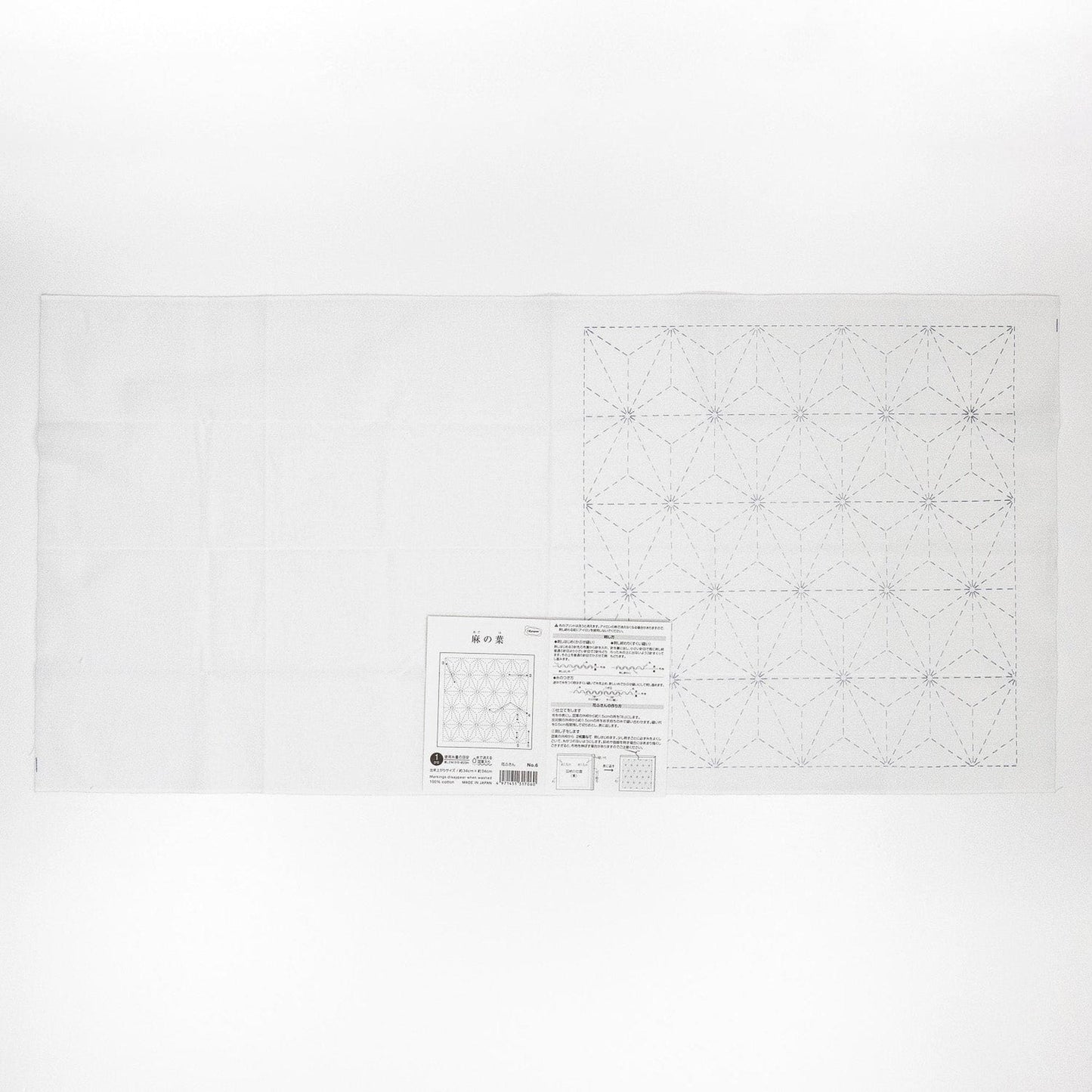 The image is a white sheet of paper with a detailed pattern or design, including a grid-like pattern and some text.