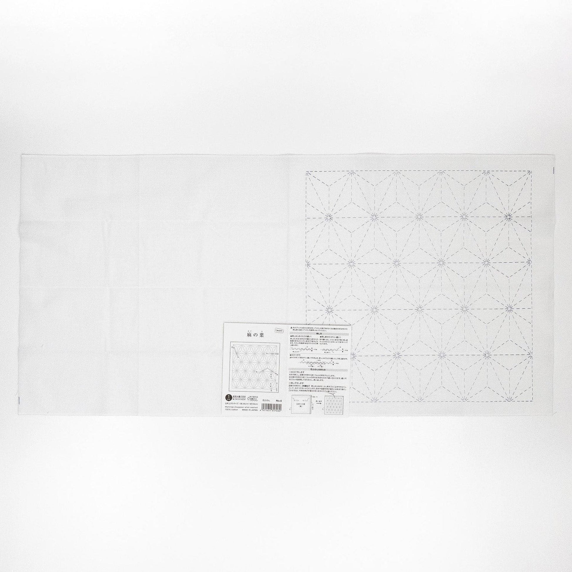The image is a white sheet of paper with a detailed pattern or design, including a grid-like pattern and some text.