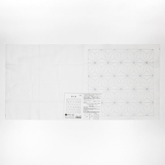 The image is a white sheet of paper with a detailed pattern or design, including a grid-like pattern and some text.