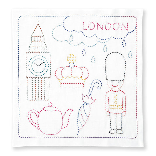 The image is a hand-stitched embroidered design featuring various elements associated with London, including Big Ben, a guard, a teapot, and a cloud with the word "LONDON" written on it.