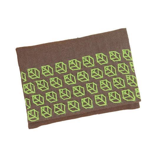 a brown fabric with a repeating pattern of green leaf-like shapes.