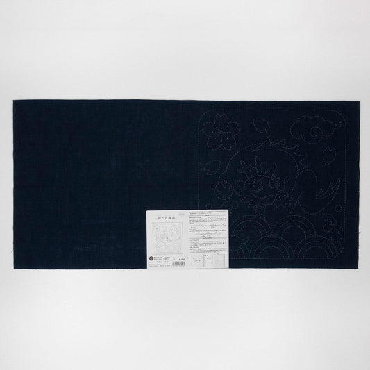 The image is a black fabric with a white label attached to it, which appears to be a sewing pattern or instructions.