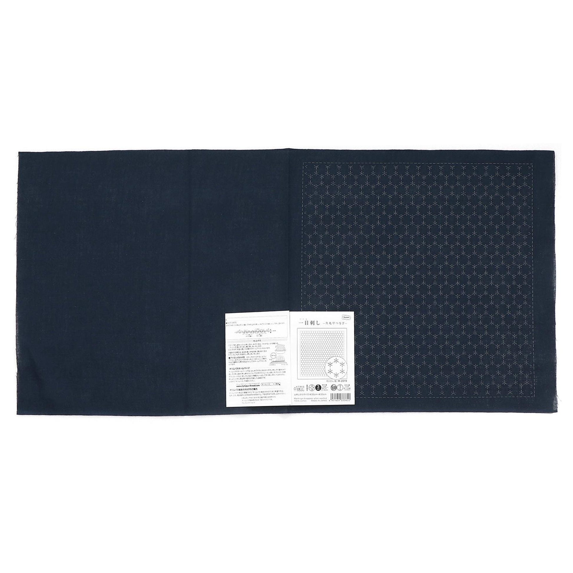 The image is a black fabric with a white label attached to it, which appears to be a product label or instructions.