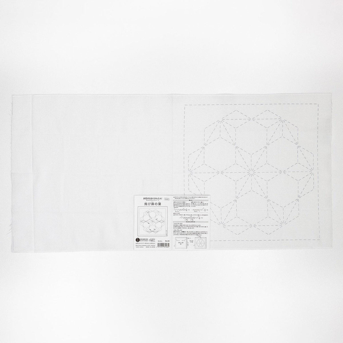 The image is a white piece of paper with a geometric pattern or design, possibly a quilt pattern, and some text or instructions related to the pattern.