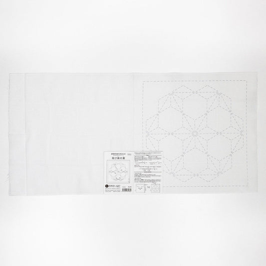 The image is a white piece of paper with a geometric pattern or design, possibly a quilt pattern, and some text or instructions related to the pattern.
