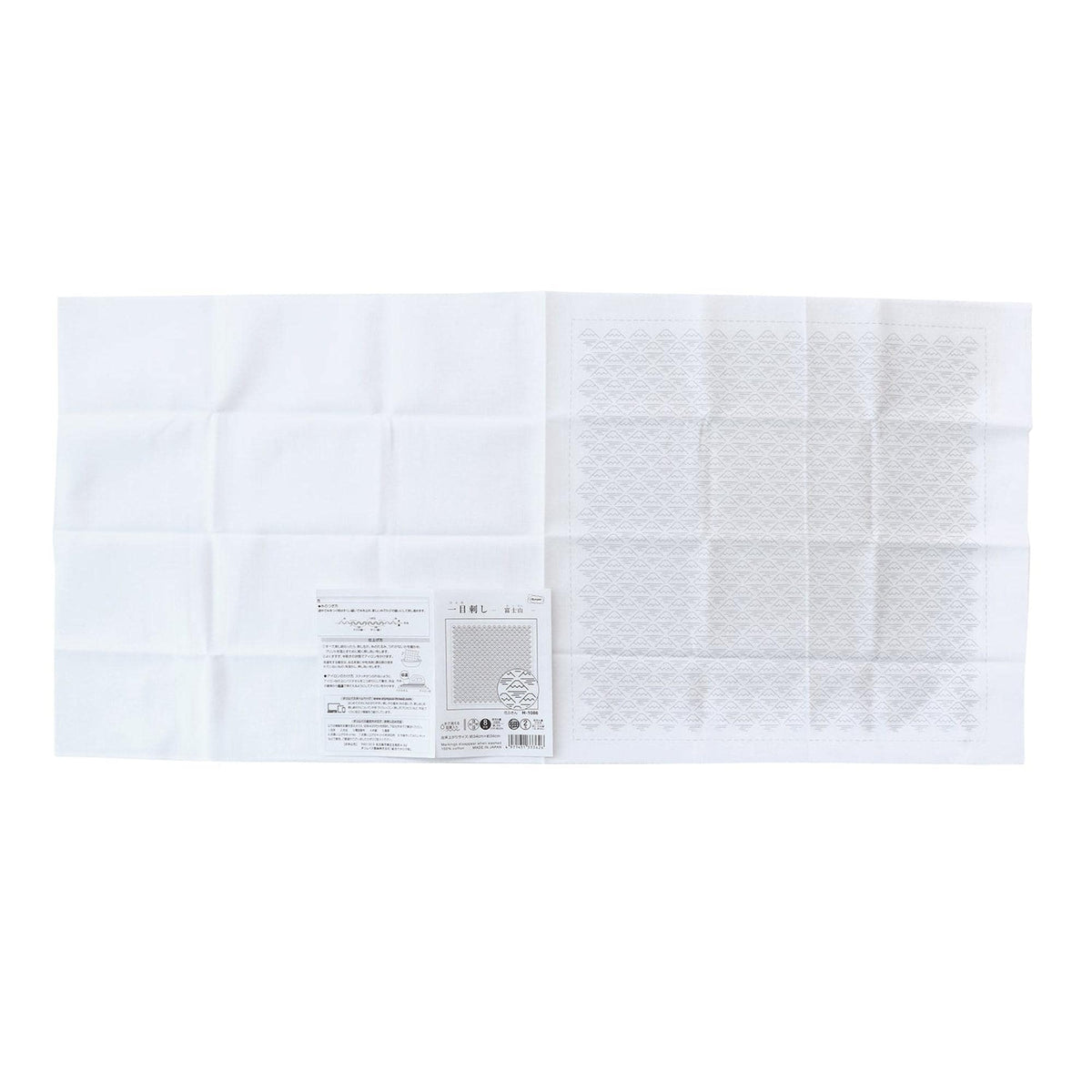 The image is a white square with a small piece of paper with text and a barcode on it, placed on top of it.