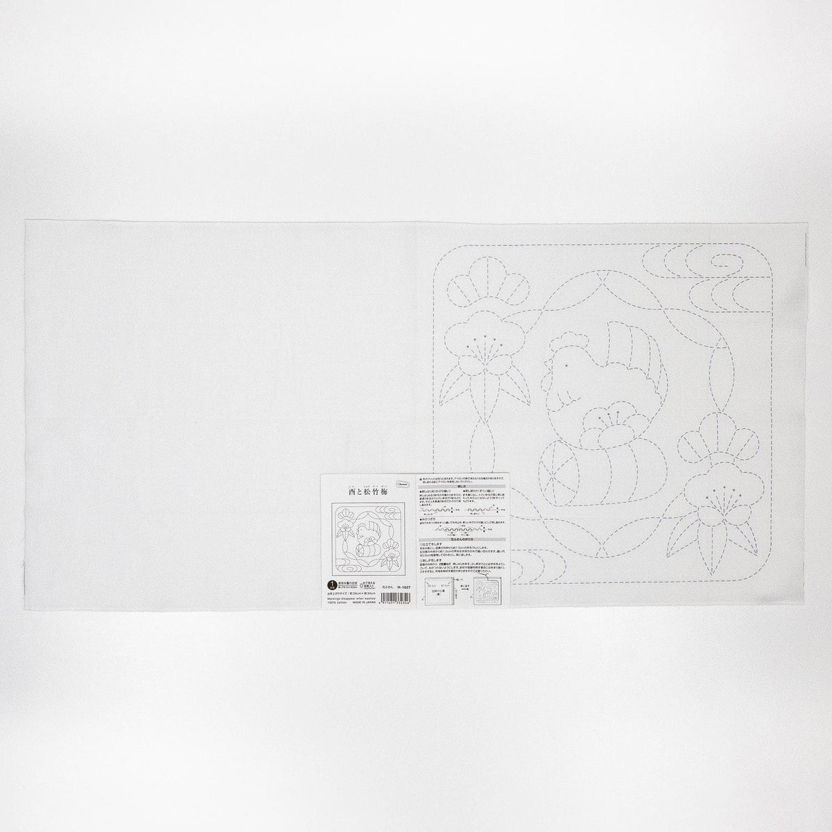 The image is a white sheet of paper with a black and white line drawing of a floral pattern on it.