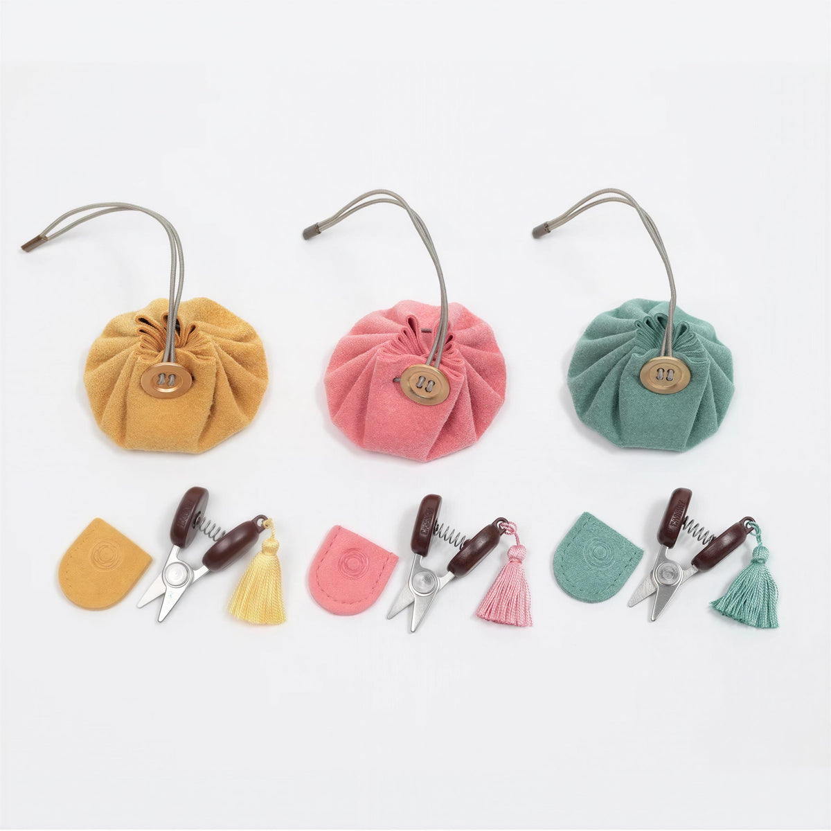 a collection of colorful fabric pouches, scissors, and tassels arranged on a white background.
