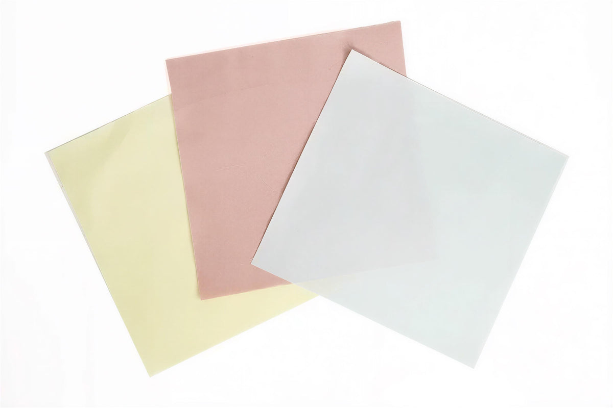 three different colored papers, including yellow, pink, and white, arranged in a triangular formation.