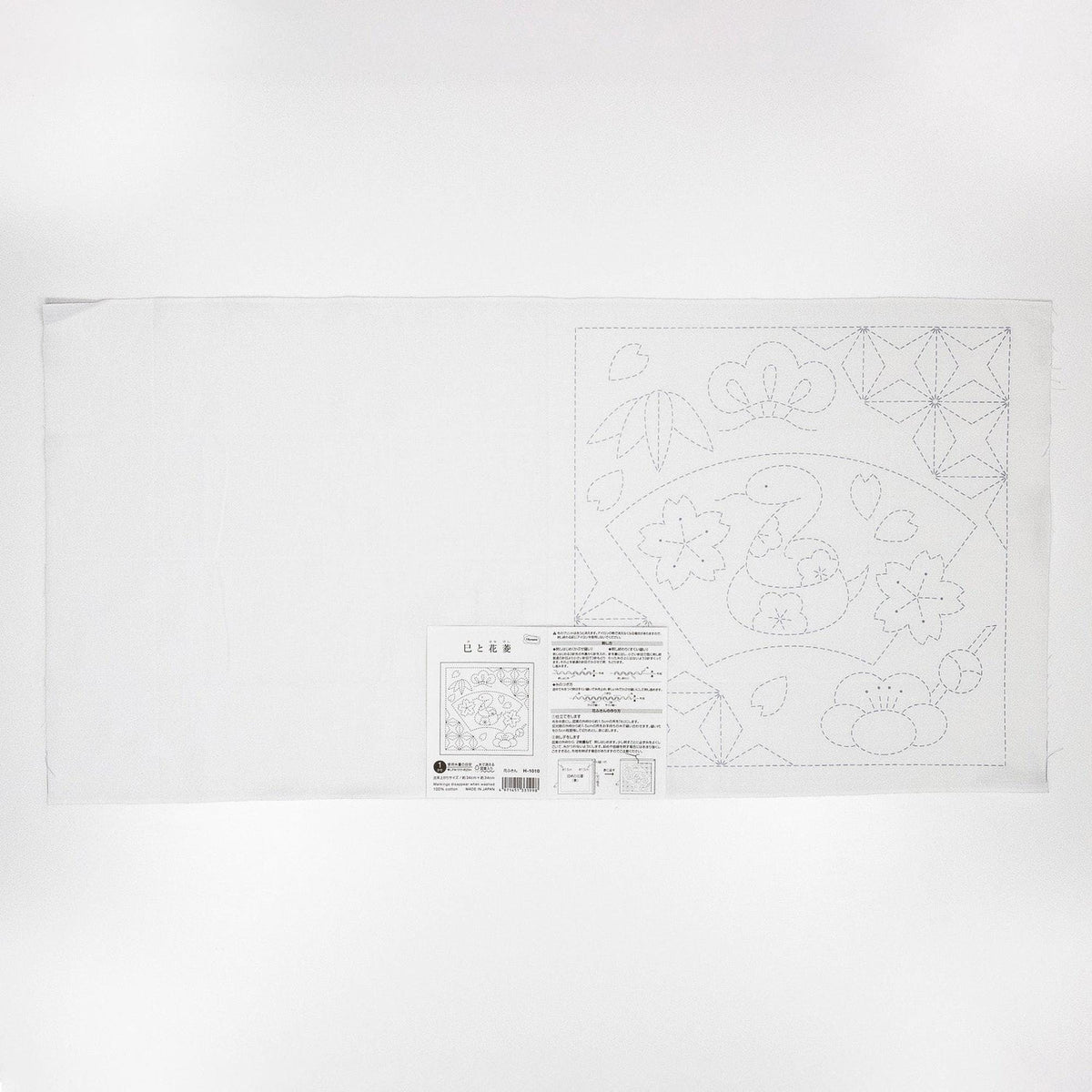 The image is a white sheet of paper with a detailed embroidery pattern and instructions for creating a similar design.