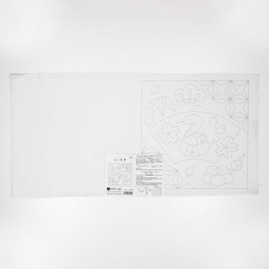 The image is a white sheet of paper with a detailed embroidery pattern and instructions for creating a similar design.