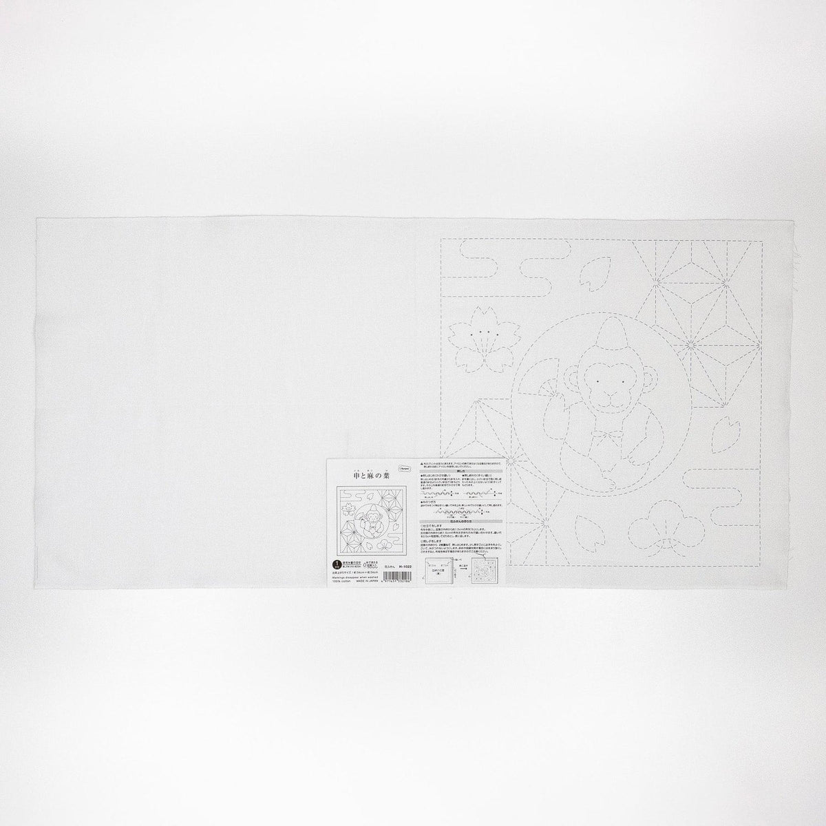 The image is a white sheet of paper with a black and white illustration of a monkey and some geometric shapes.
