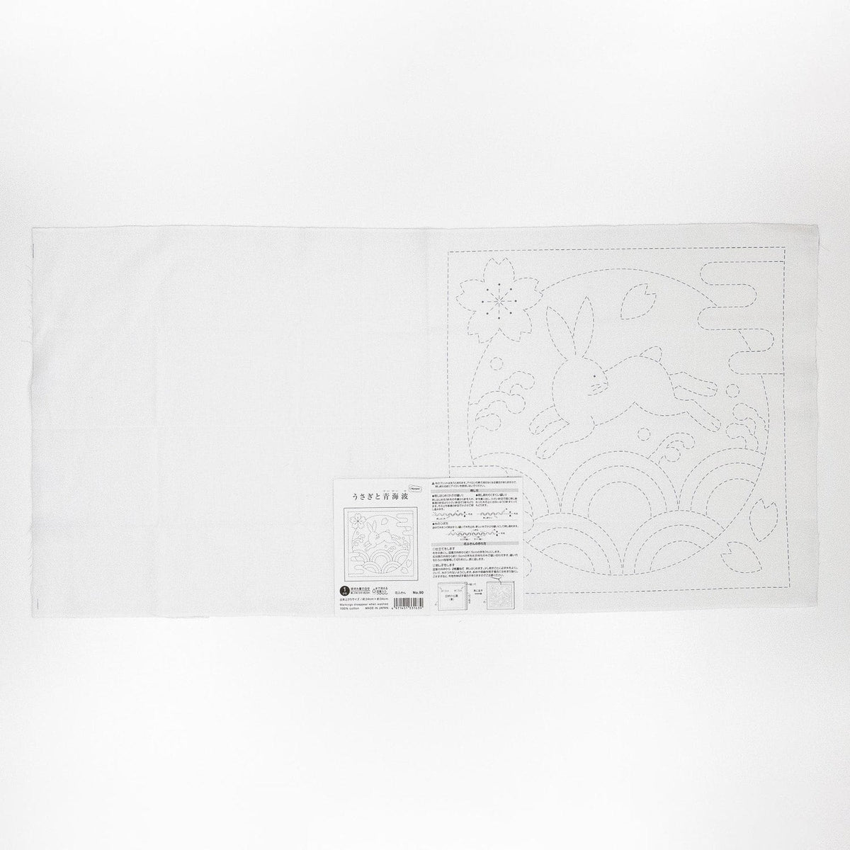 The image is a white piece of paper with a black and white illustration of a rabbit and a flower.