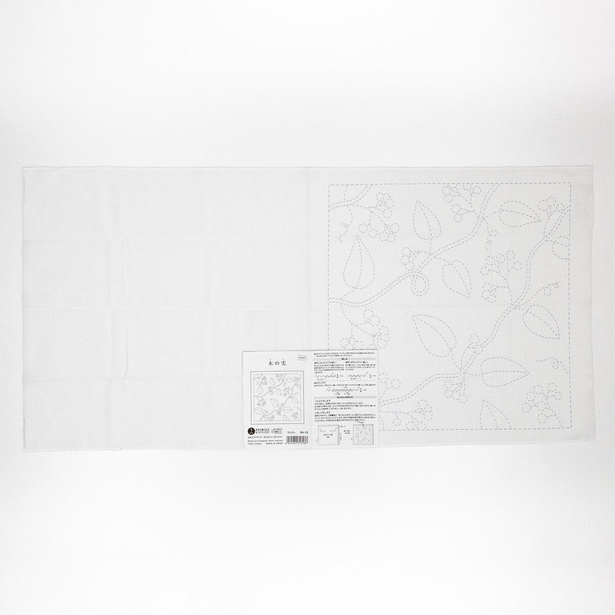 The image is a white square with a pattern of leaves and flowers on it, along with some text and a barcode.