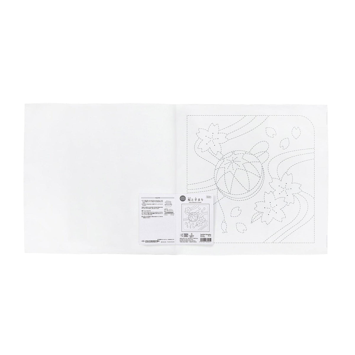 The image is a white sheet of paper with a black and white line drawing of a flower and leaves on it.