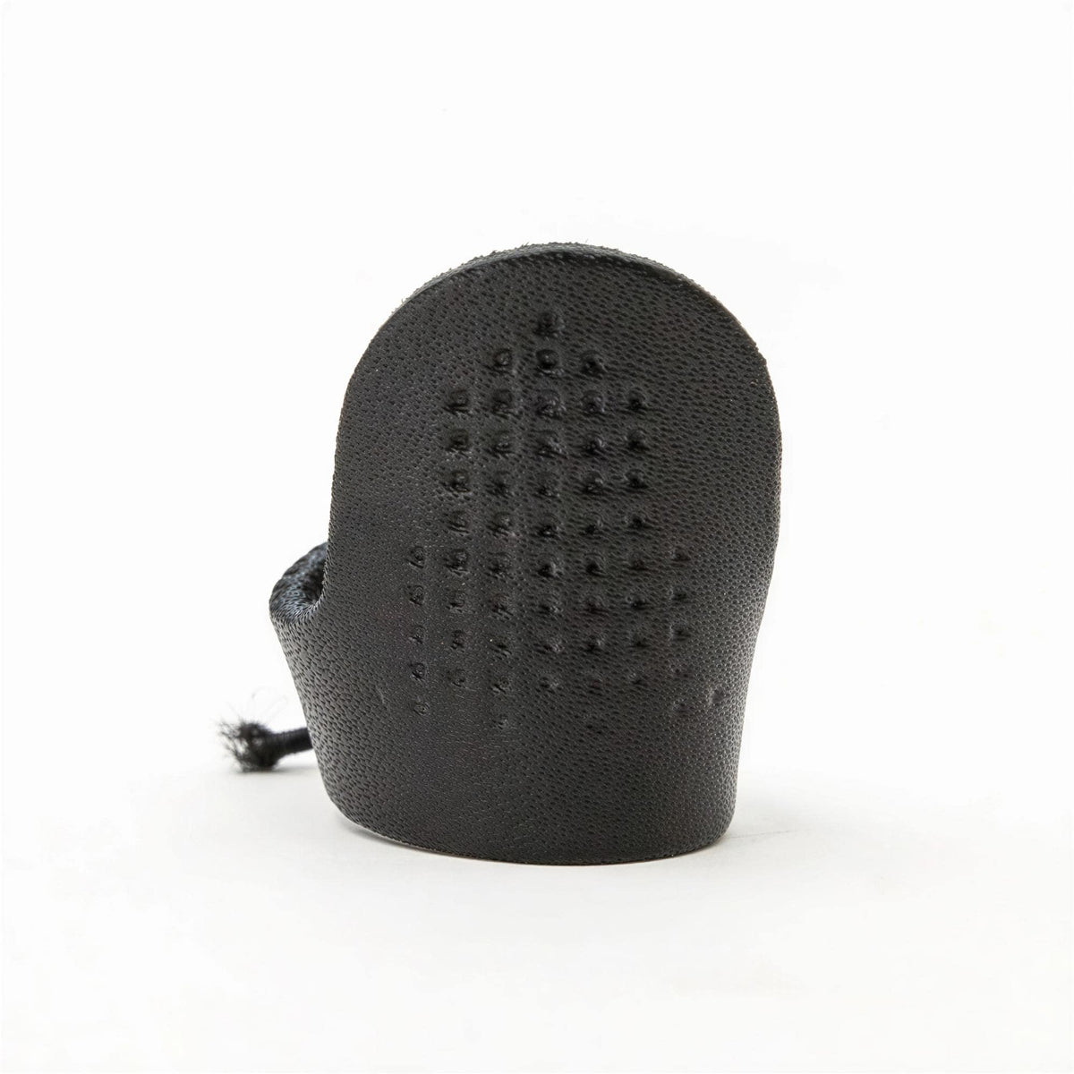 A black rubber or leather object with a grid-like pattern on its surface.