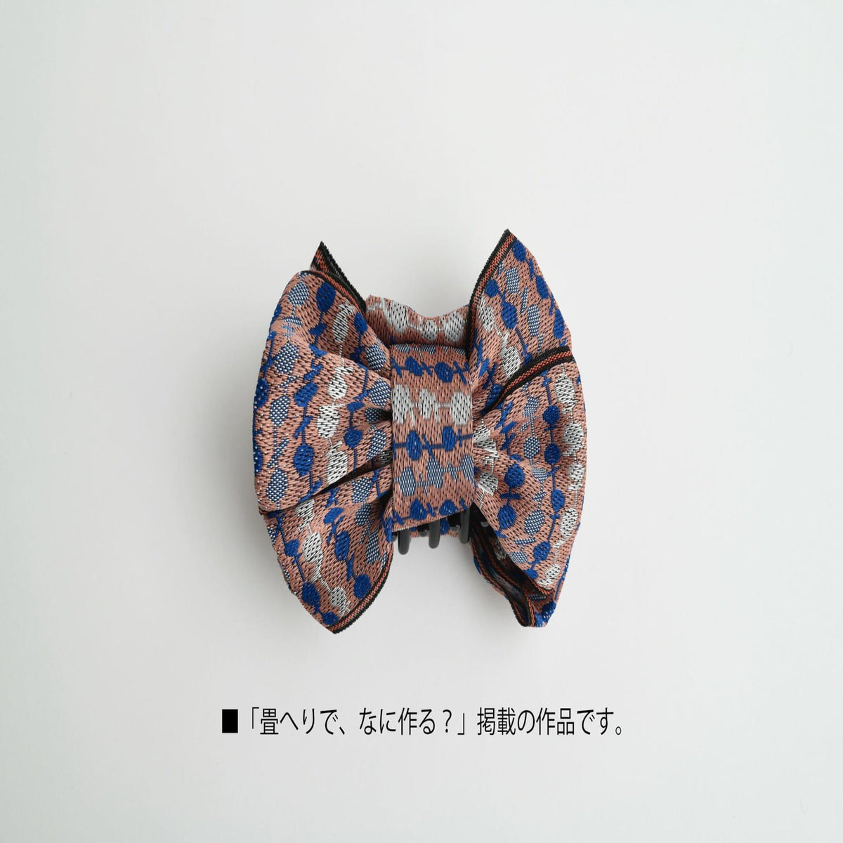 A decorative bow tie with a patterned design, displayed against a plain white background.
