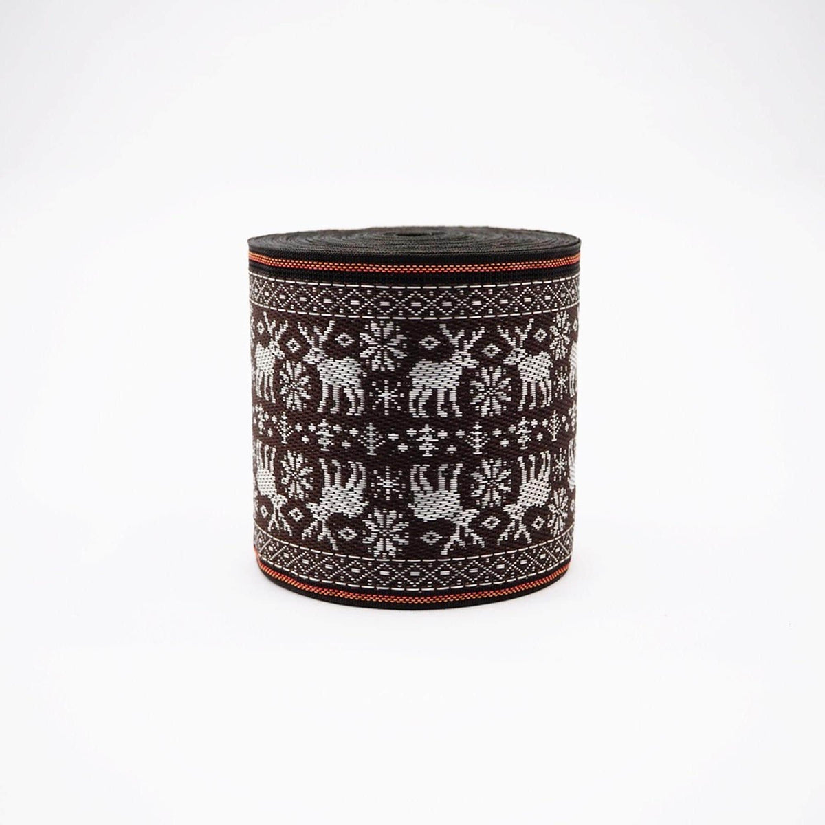 A cylindrical object with a black and white pattern featuring deer and snowflakes.
