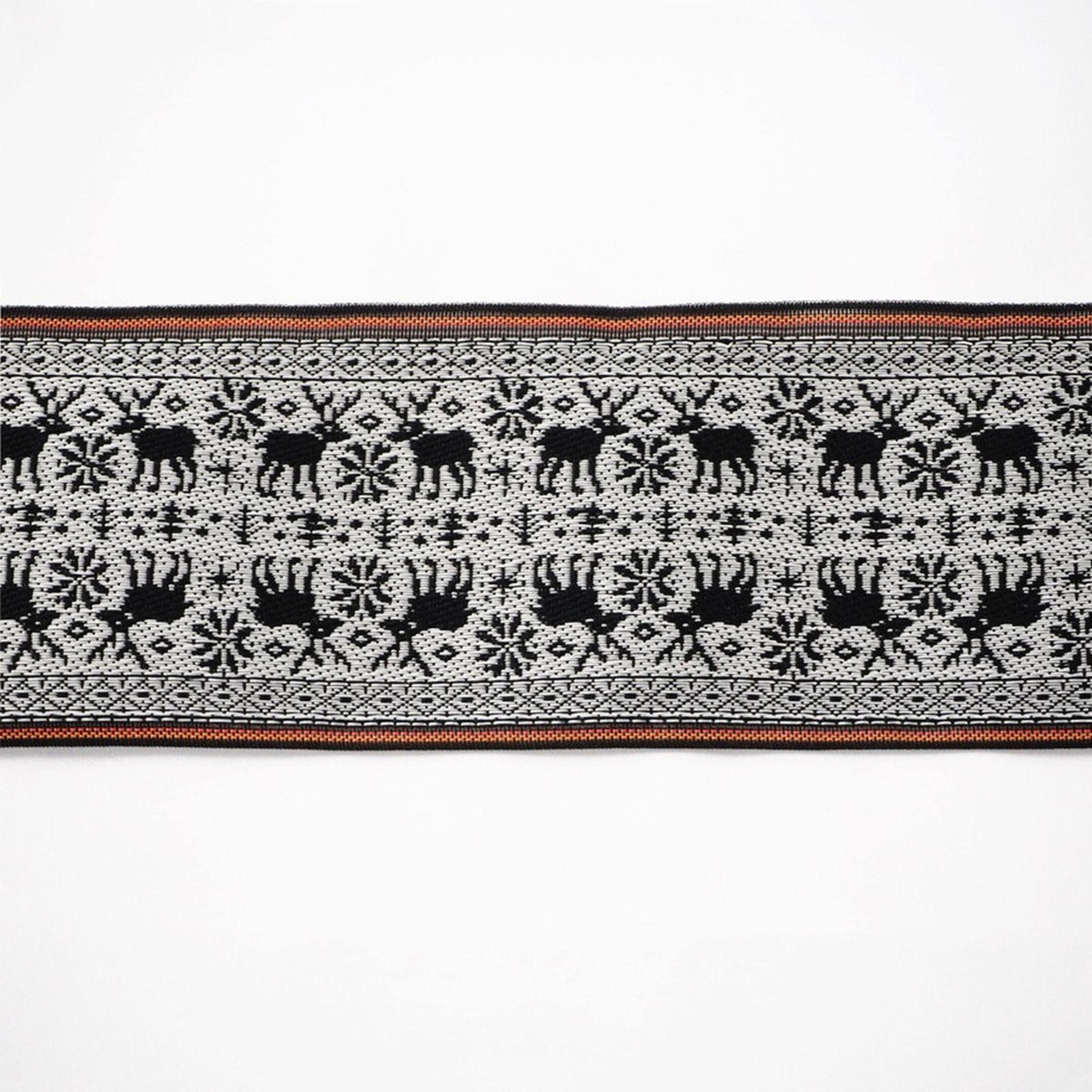 a black and white pattern with a repeating design of deer and snowflakes.