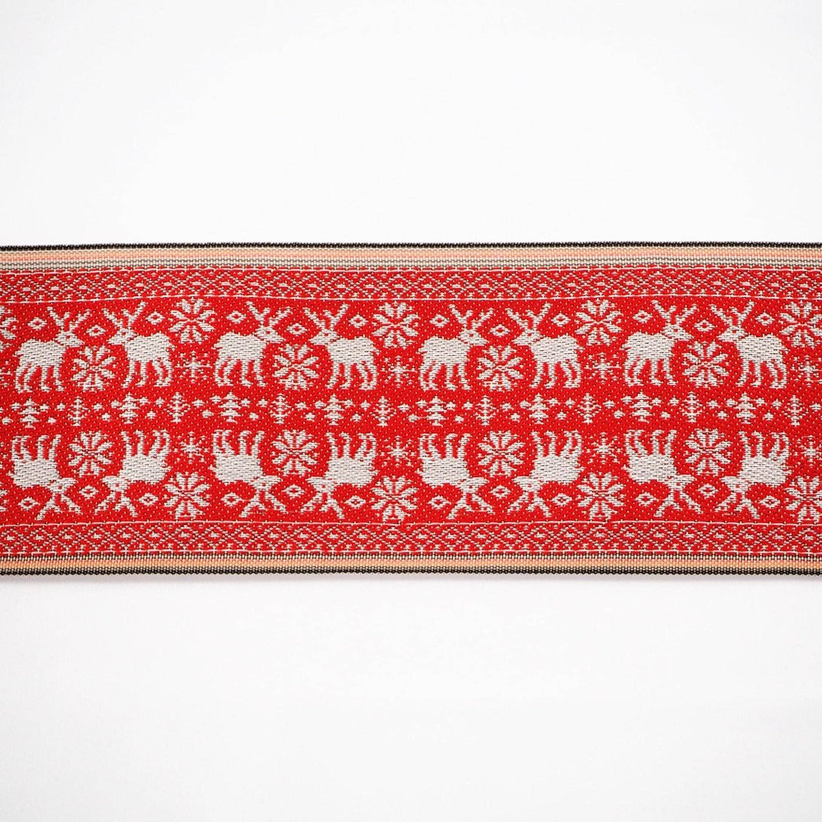 a red and white patterned fabric with a repeating design of elephants and snowflakes.
