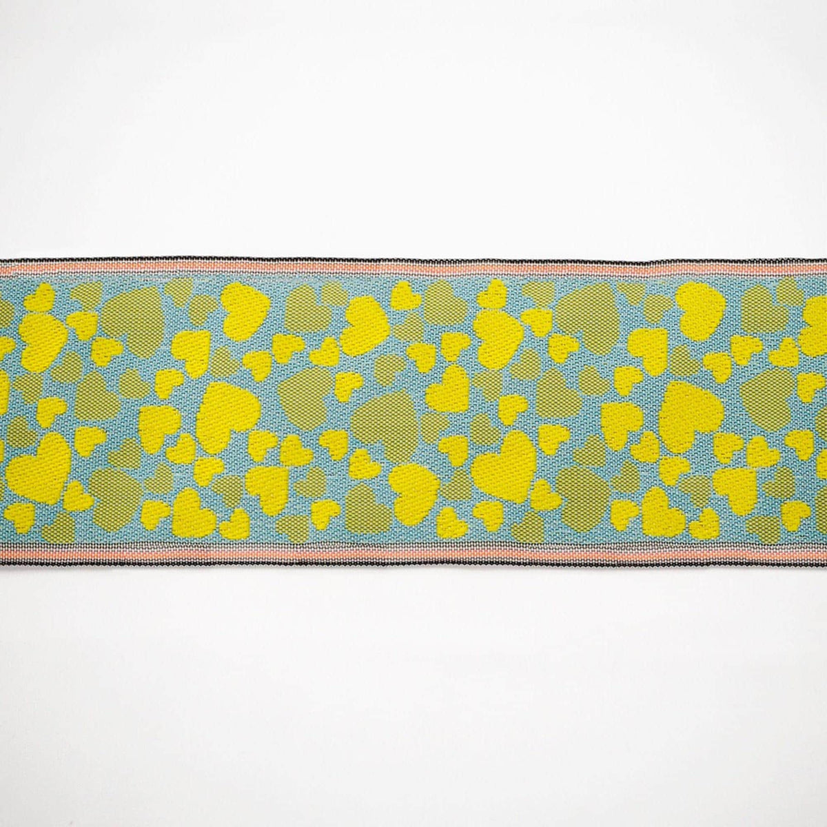 a close-up view of a fabric with a heart-shaped pattern in shades of yellow and blue.