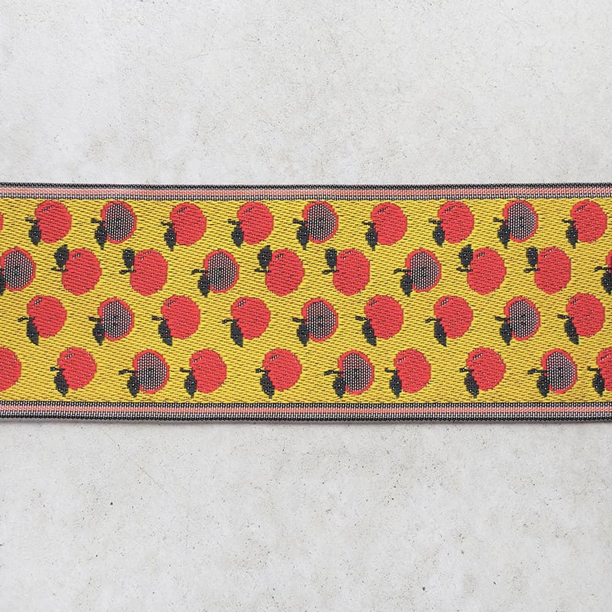 a repeating pattern of red and yellow apples on a white background.
