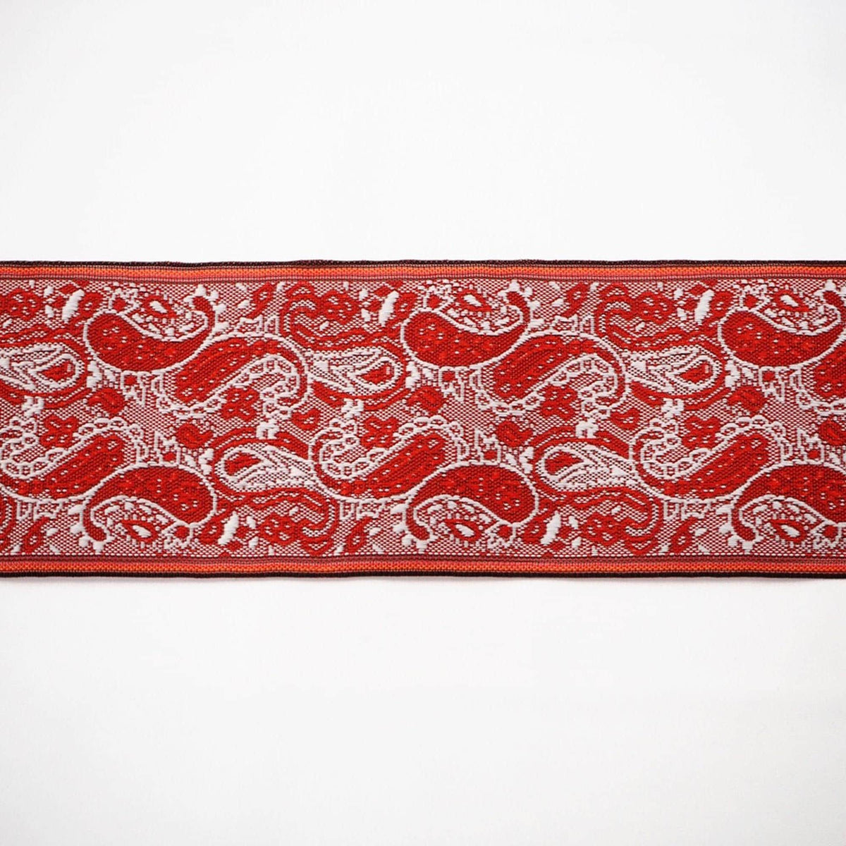 a red and white paisley pattern with a black border.