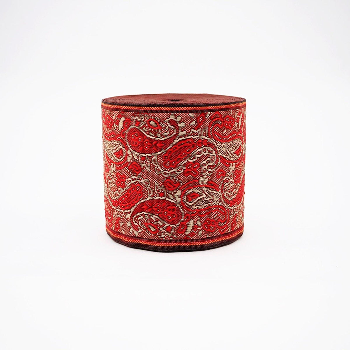A cylindrical object with a red and white paisley pattern, featuring a black border.