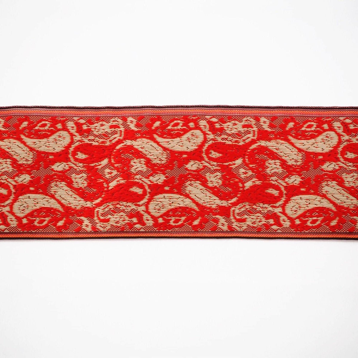 a red and white patterned fabric with a repeating paisley design.