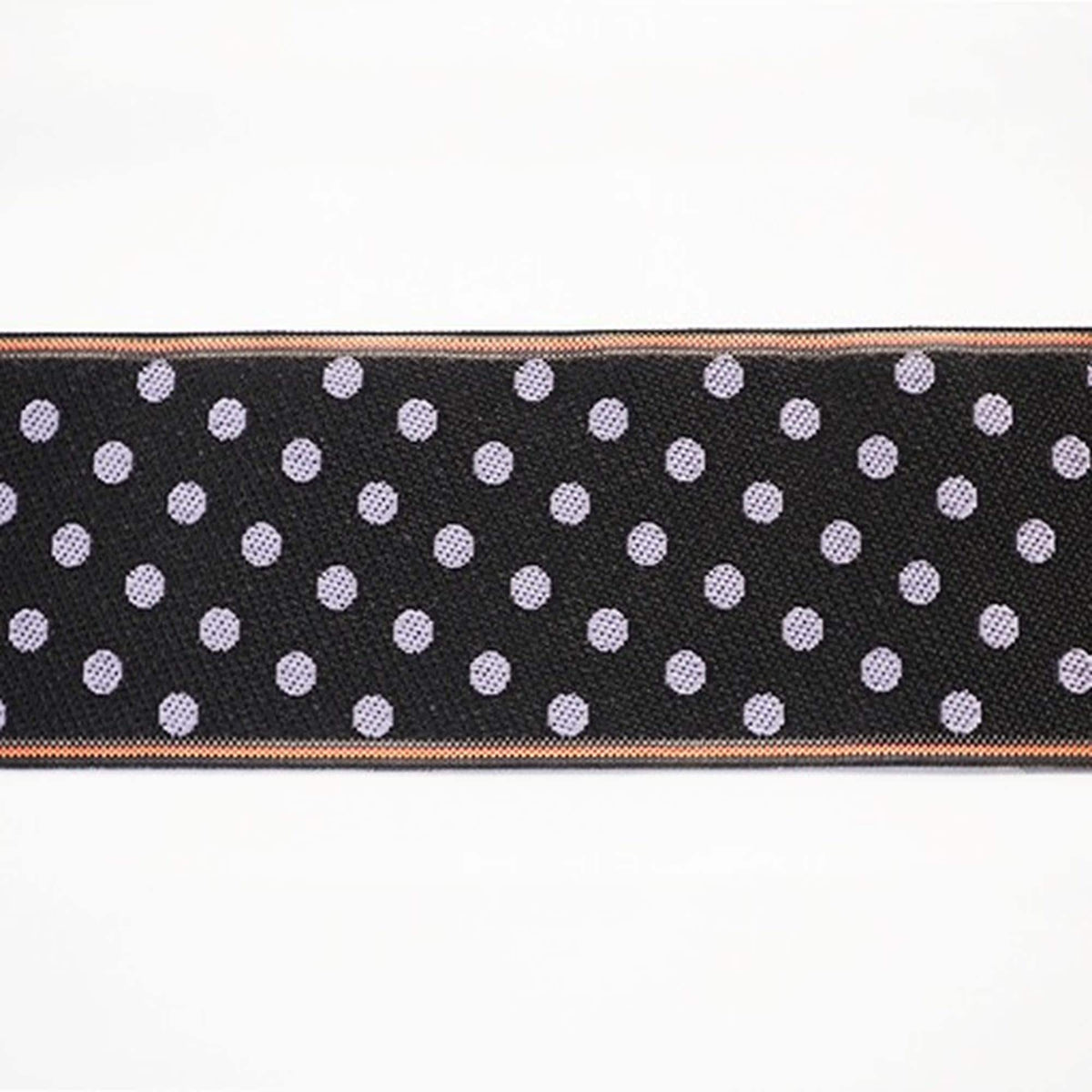 a close-up view of a black fabric with white polka dots, creating a visually striking pattern.