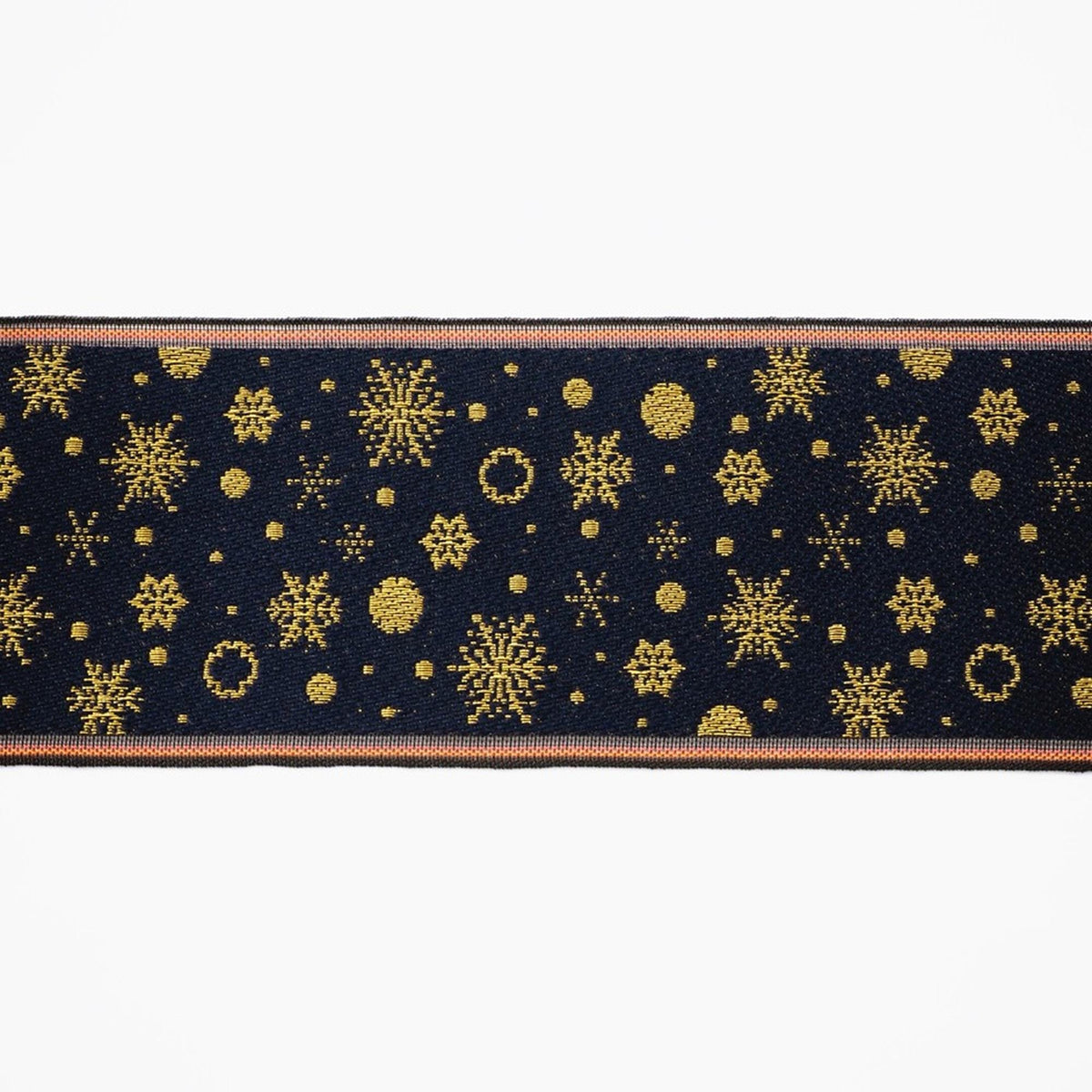 a black and gold pattern with numerous snowflakes and stars on a dark background.