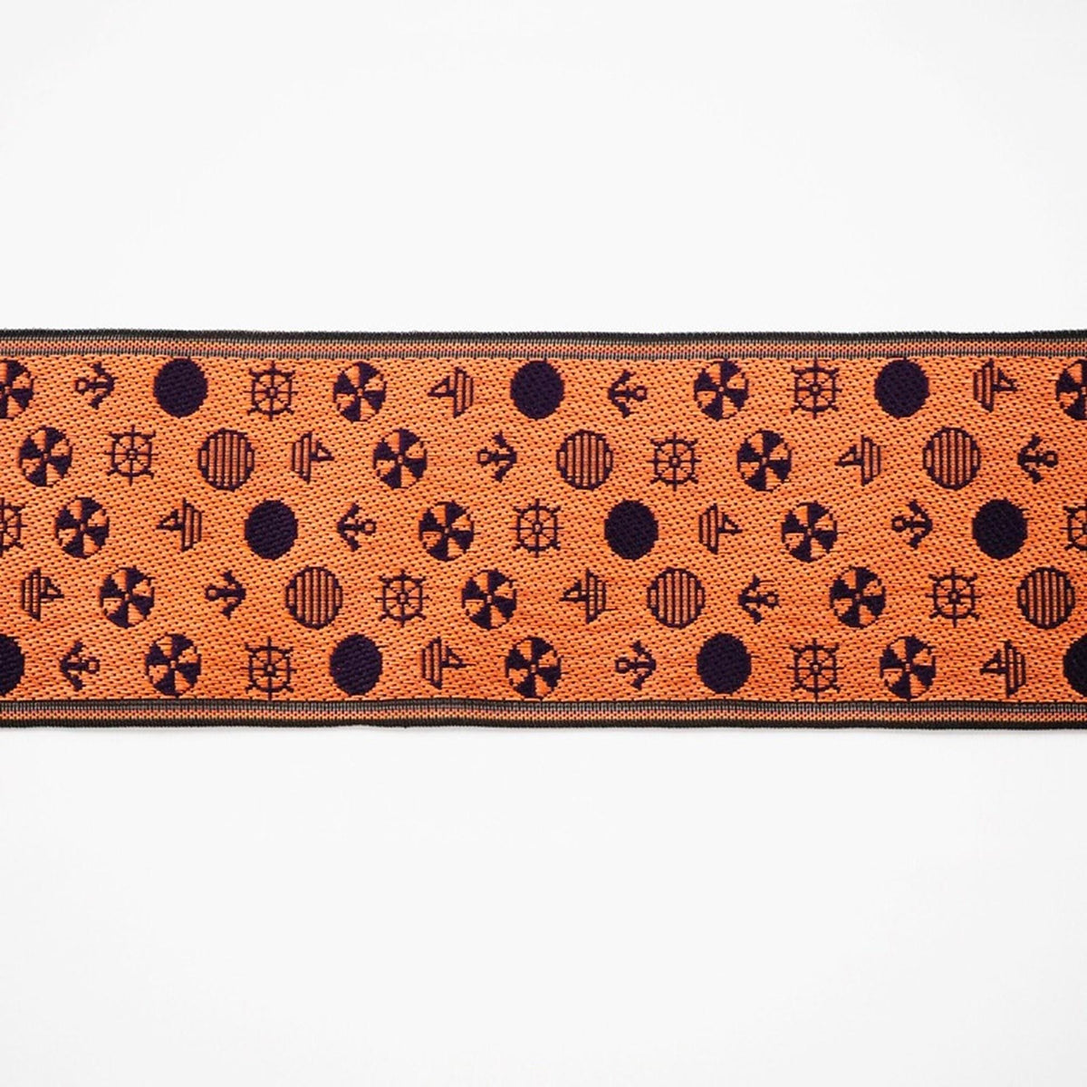 a repeating pattern of orange and black circles and symbols on a white background.