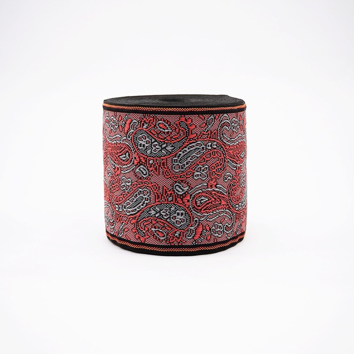 a round, cylindrical object with a paisley pattern in red, black, and gray colors.