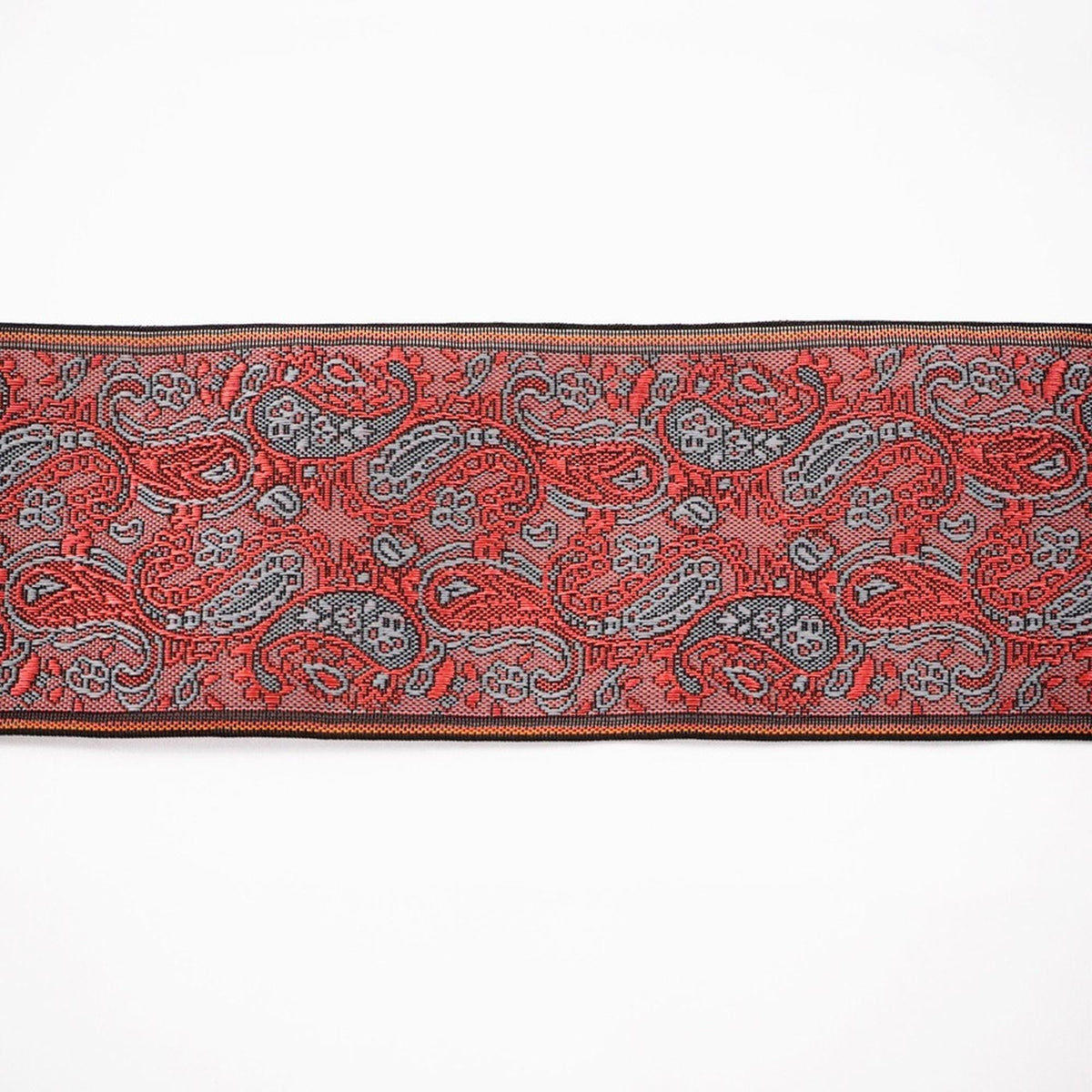 a decorative border with a repeating pattern of red and gray paisley designs.