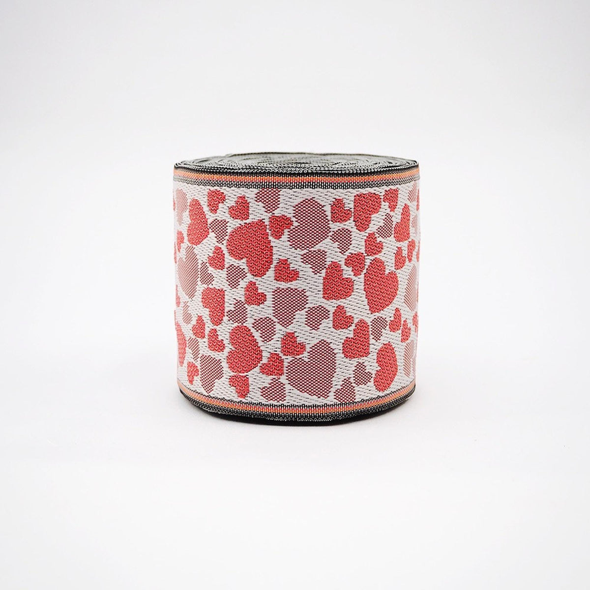 A round object with a heart-shaped pattern on it, featuring red and white hearts.