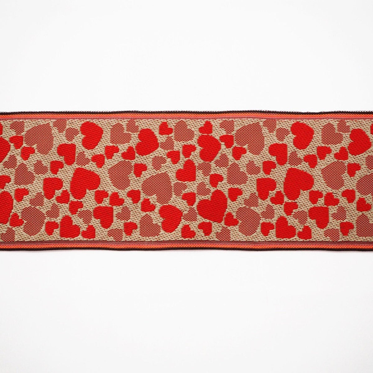 a red and brown heart-patterned fabric or ribbon.