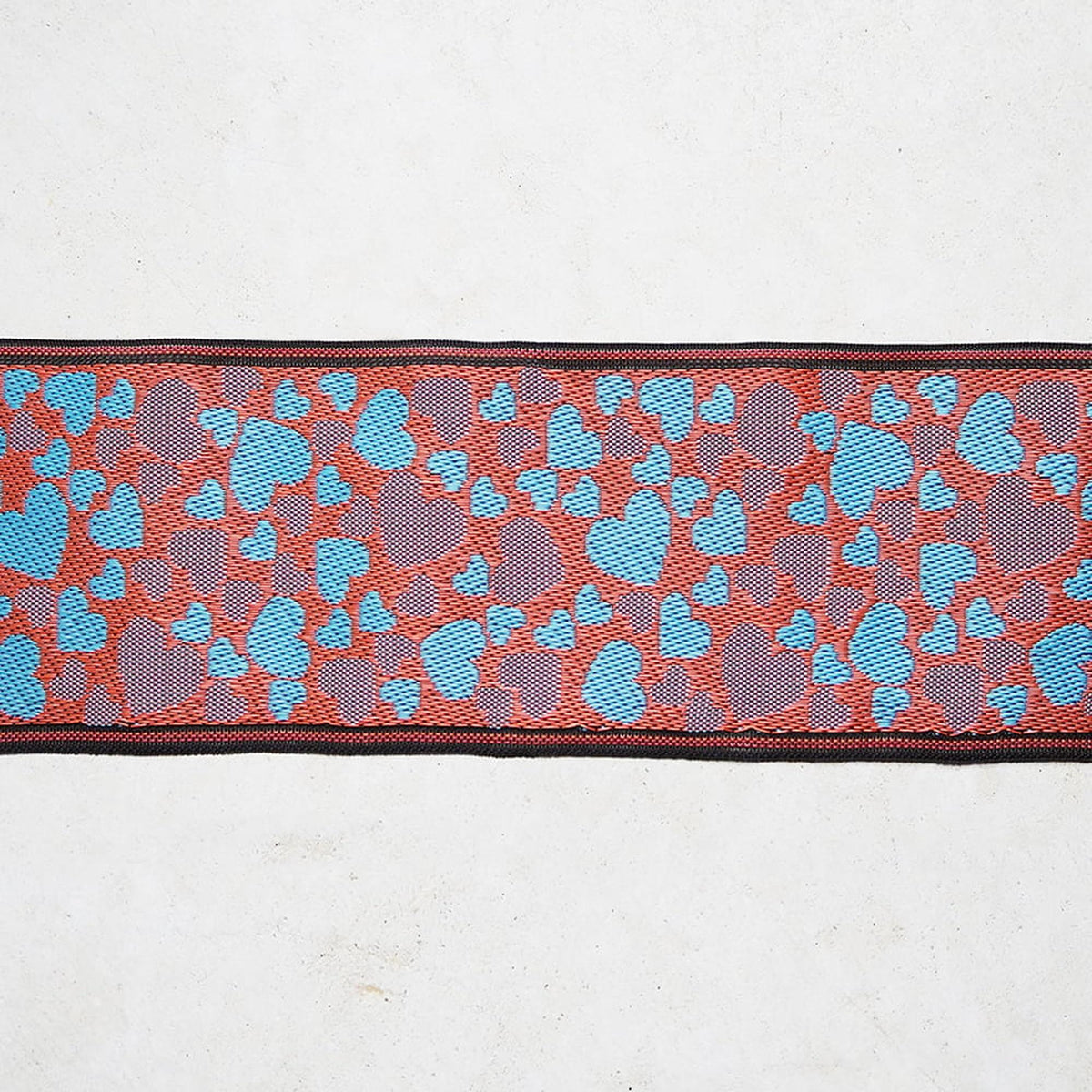 a patterned fabric with a repeating design of blue and orange shapes on a white background.